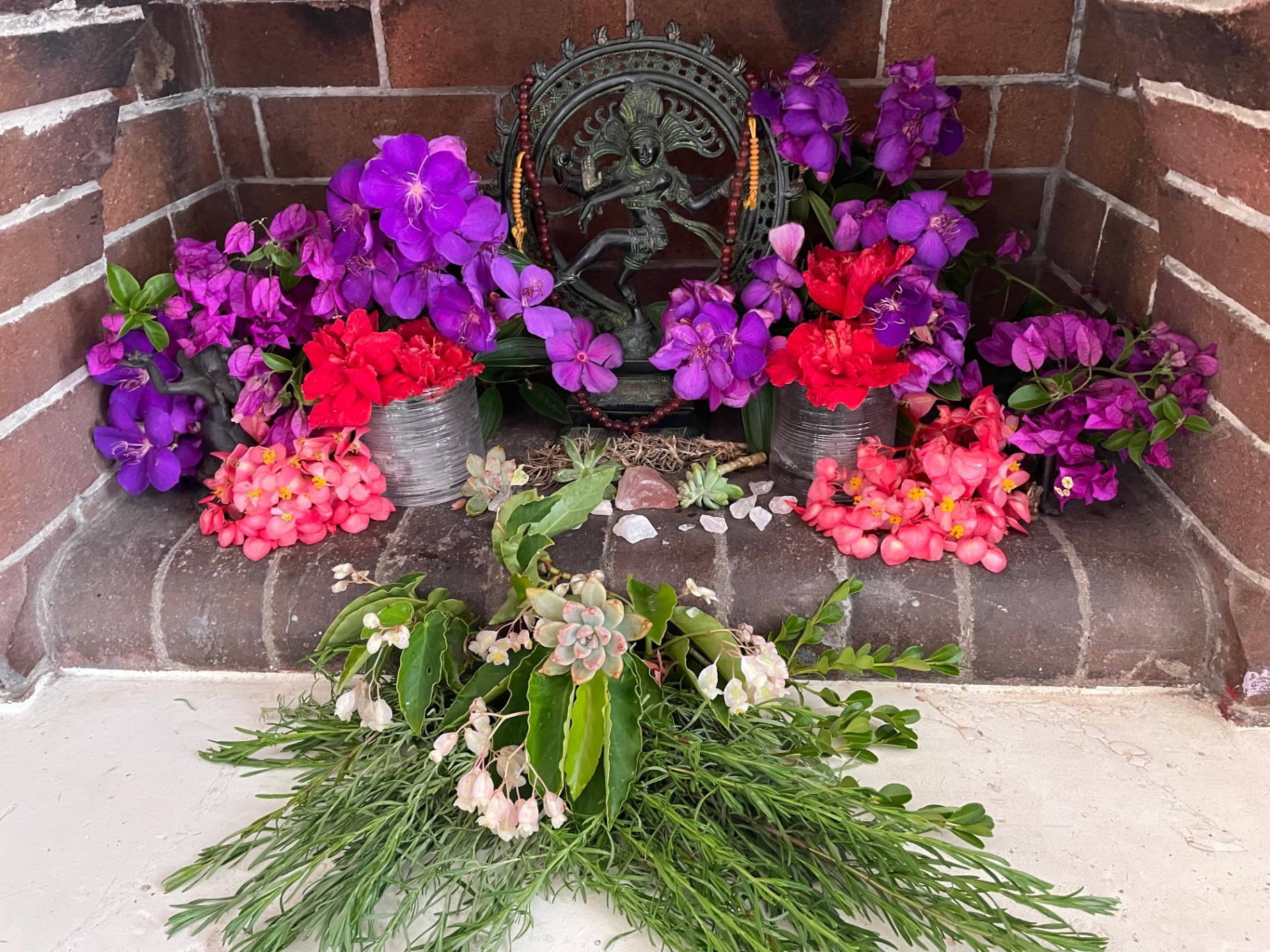 Healing altar with flowers, crystals and Nataraja statue