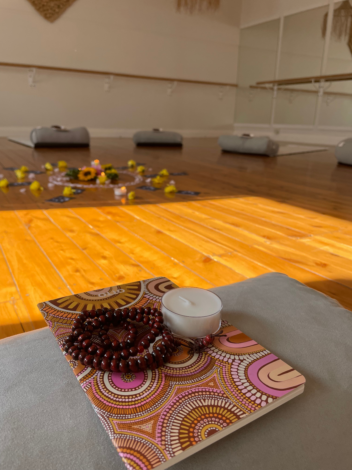 Meditation space with mala beads and candle for somatic practice